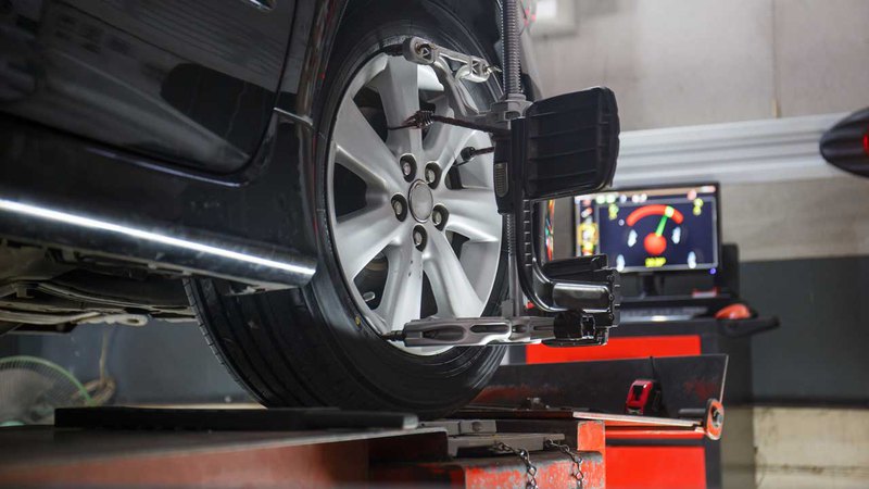 Car being aligned on an alignment apparatus for tire alignment; how long does an alignment take?