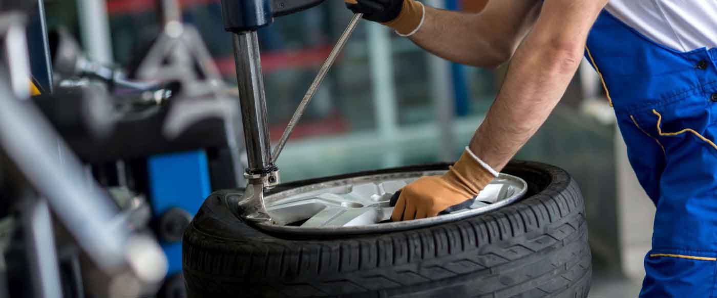 specialist in the middle of professional tire repair process